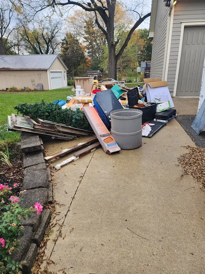 Dumpster being loaded with debris for 3 Yard Dumpster Rental in Progress Village